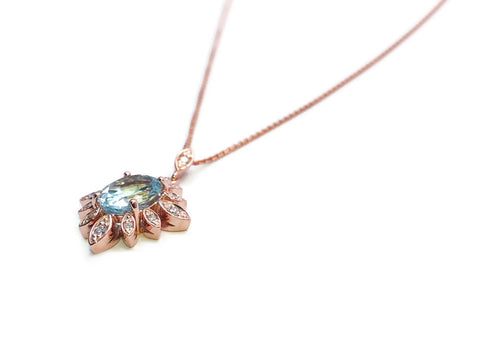 Pink gold pendant in the shape of a sun with diamond pavé and aquamarine in the centre