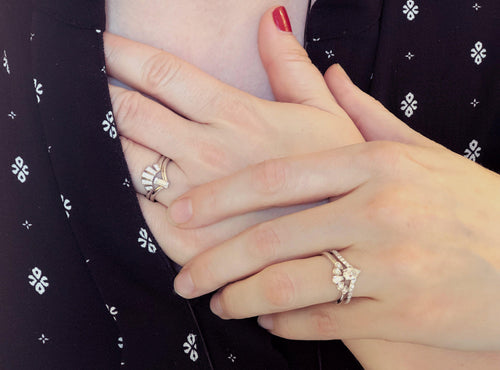 Two women's hands showing off their wedding and engagement rings