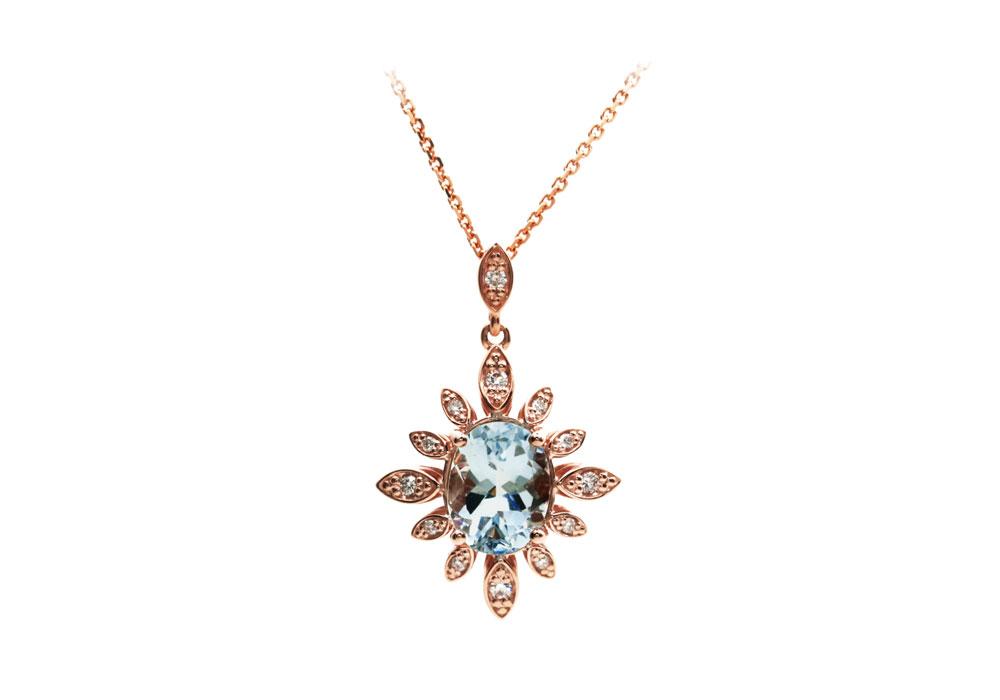 Pendant in pink gold with an aquamarine in the center and small diamonds in the sun look